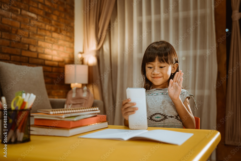 little girl video conference with her school mate and teacher in the evening little girl video conference with her school mate and teacher in the evening