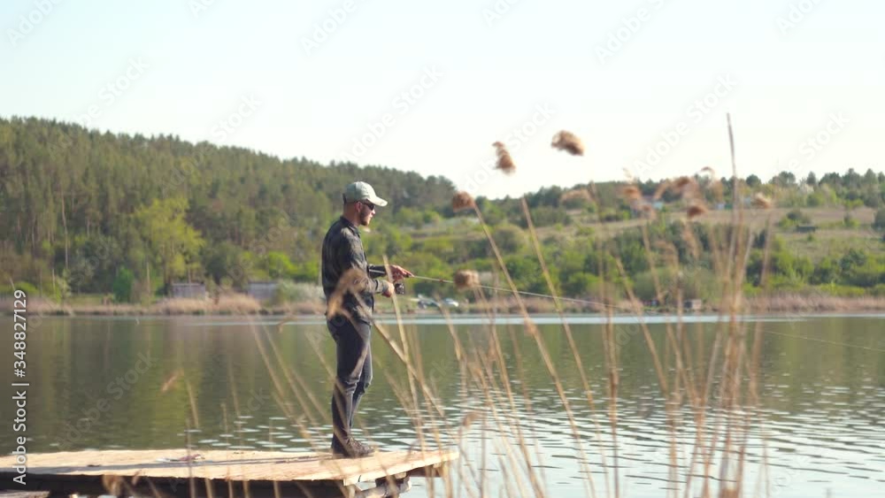 Fisherman cast fishing rod in lake or river water. Spinning fishing predatory fish Fisherman cast fishing rod in lake or river water. Spinning fishing predatory fish