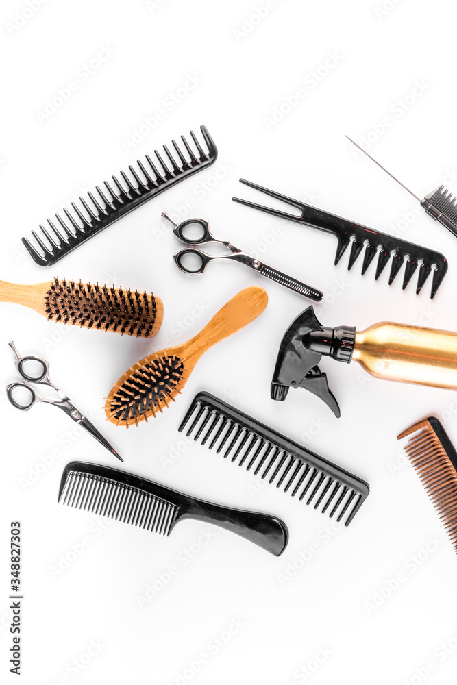 Hairdressing instruments. Combs, scissors and spray on white desk from above space for text Hairdressing instruments. Combs, scissors and spray on white desk from above space for text