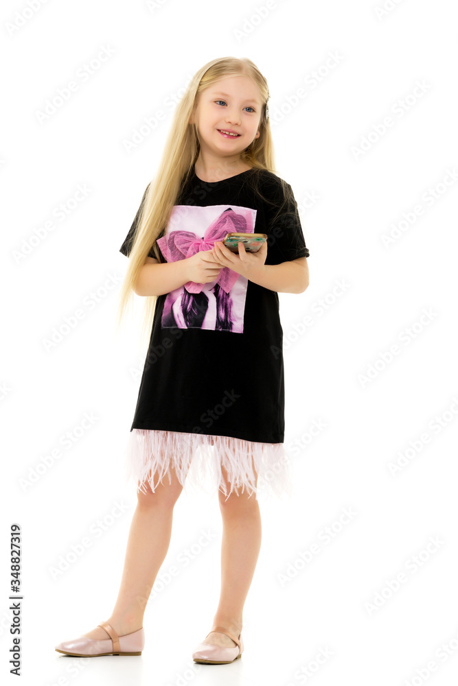 The girl is using a cell phone.The concept of people and technol The girl is using a cell phone.The concept of people and technol