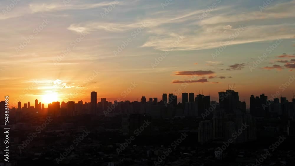 Natural view of nature, sun setting behind silhouetted skylines. cityscape shot dusk hour Natural view of nature, sun setting behind silhouetted skylines. cityscape shot dusk hour