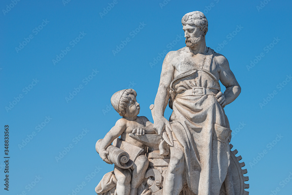 Elderly and young – old sculpture of engineer and his scholar on Zoll Bridge in Magdeburg downtown at blue sky background, Germany, details, closeup