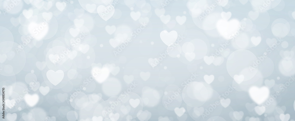 Glowing soft blue bokeh background. Spring concept. Blurred bokeh circles and hearth shapes.