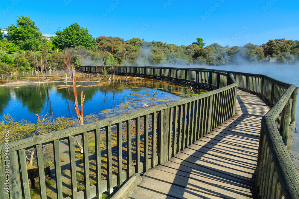 A wooden walkway across the steaming hot geothermal lake in Kuirau Park, Rotorua, New Zealand A wooden walkway across the steaming hot geothermal lake in Kuirau Park, Rotorua, New Zealand