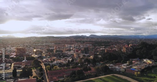 Golden Hour Ascending Drone Shot of City Skyline with Buildings photo