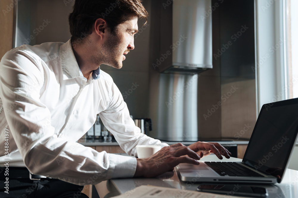 Photo of thinking bristle businessman working with laptop Photo of thinking bristle businessman working with laptop