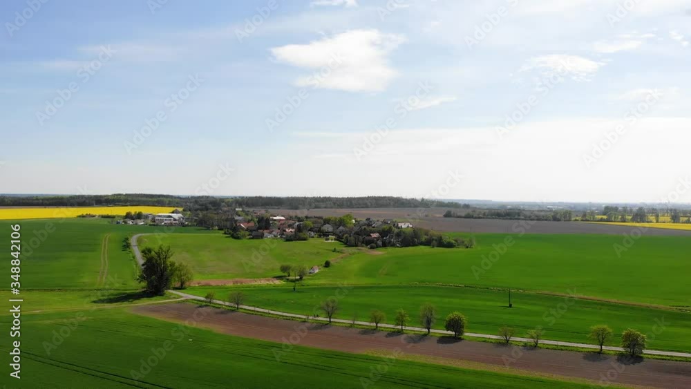 small village in Central Europe in spring, green fields and meadows in spring, preparation for the agricultural season small village in Central Europe in spring, green fields and meadows in spring, preparation for the agricultural season