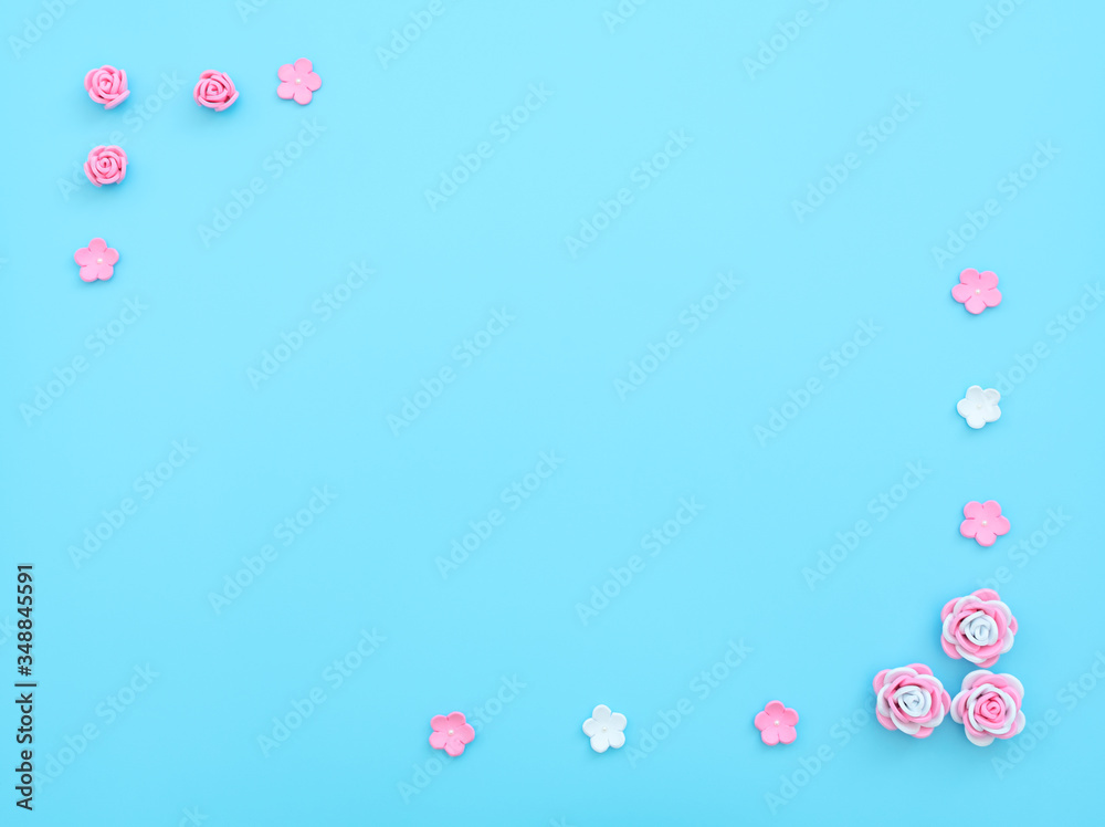 Pink and white flowers made of foamiran on blue background. Mother day, Valentine day, Wedding, Birthday concept. Greeting or invitation card. Flat lay with copy space.