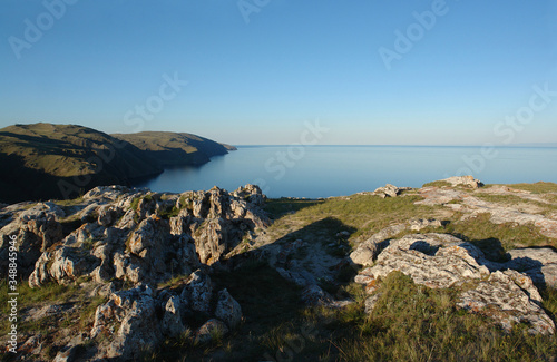 Beautiful view of Baikal Lake from the high cliffs Cape Ulan-Zaba on a clear summer evening (area of Aya bay in Tazheranskaya / Tazheran steppes), Siberia, Russia photo