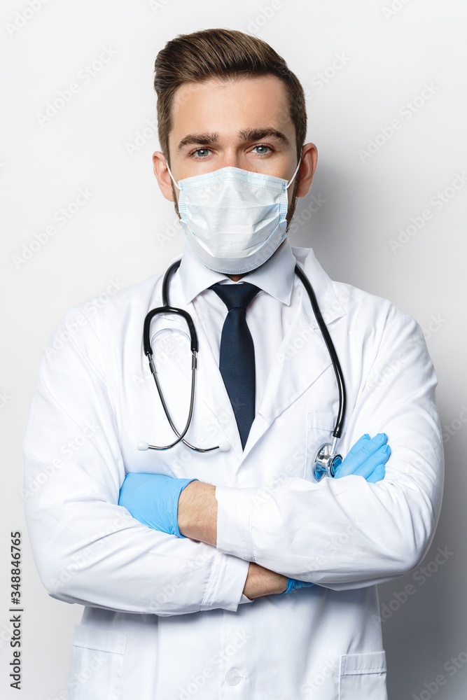 Doctor with the stethoscope wearing prevention mask and latex gloves Doctor with the stethoscope wearing prevention mask and latex gloves