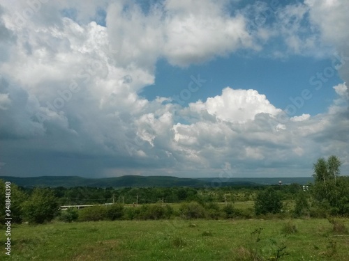 stormy clouds over green forest in summer season