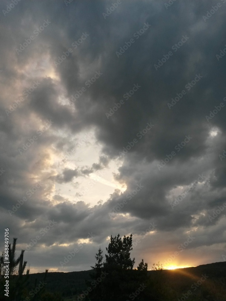stormy clouds over green forest in summer season stormy clouds over green forest in summer season