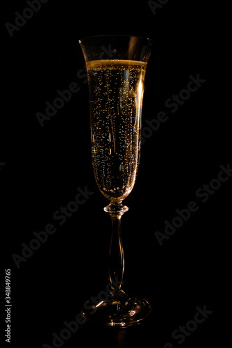 a glass of champagne in the backlight