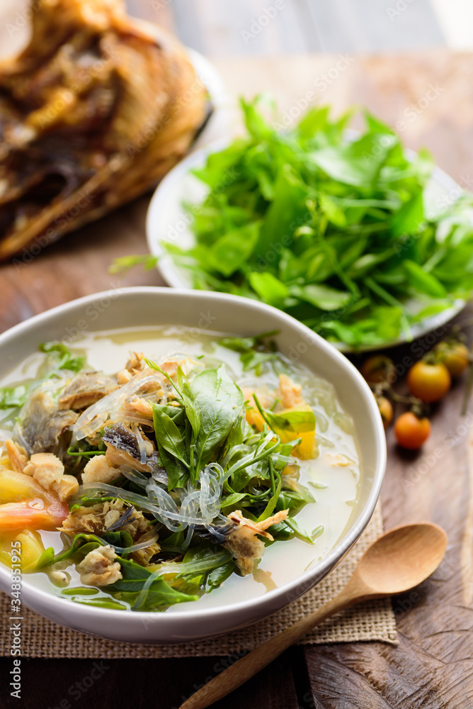 Northern Thai food (Kang Pak Wan Pa), Spicy local Thai vegetable soup with dry fish and glass noodles in a bowl on wooden background, Local Thai food Northern Thai food (Kang Pak Wan Pa), Spicy local Thai vegetable soup with dry fish and glass noodles in a bowl on wooden background, Local Thai food