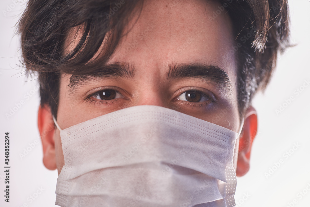 Man in a medical mask close up portrait. Healthcare. Covid-19 coronavirus symptoms