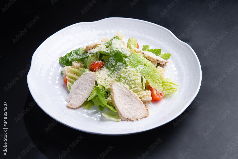 salad with chicken in a plate on a dark background salad with chicken in a plate on a dark background