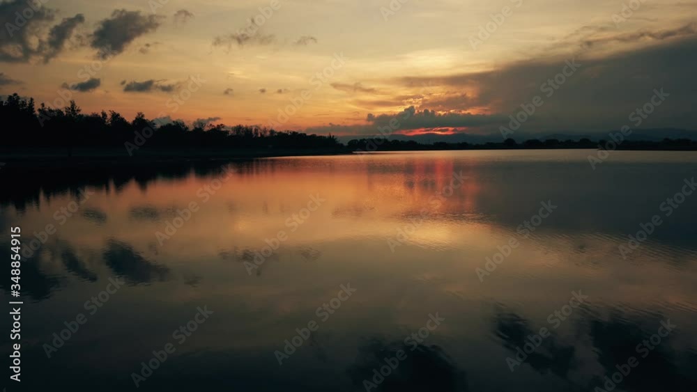 Red sunsets over lake. Red and pink sky with clouds. Summer sunset seascape. 4k Video. Red sunsets over lake. Red and pink sky with clouds. Summer sunset seascape. 4k Video.