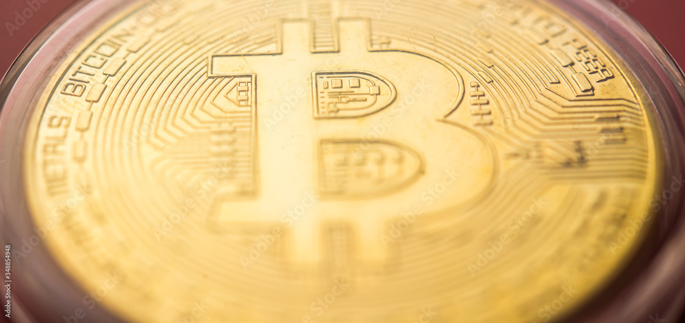 Golden Bitcoins with light background. New virtual money on internet.