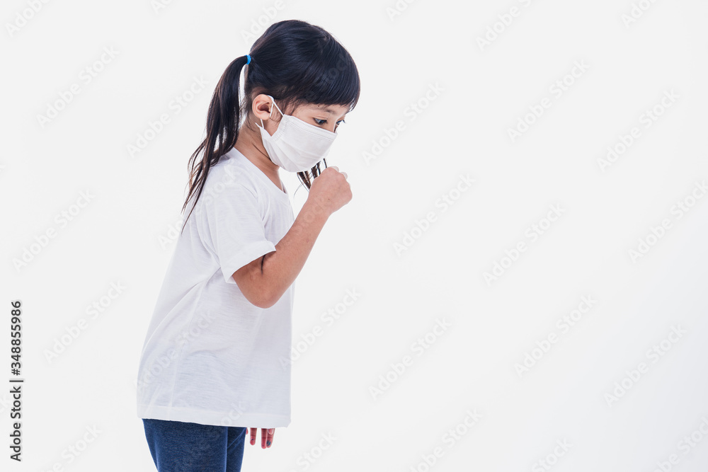 Asian little cute girl wearing a mask to protective spread the disease on white background. Prevention of spreading the corona virus COVID-19 cold flu or pollution. Asian little cute girl wearing a mask to protective spread the disease on white background. Prevention of spreading the corona virus COVID-19 cold flu or pollution.