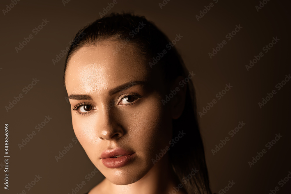 Portrait of beautiful woman looking at camera isolated on black