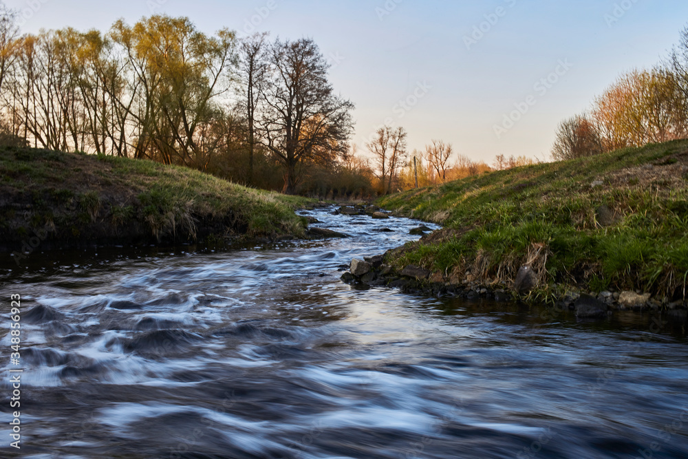 Colorful stream and evening sky at sunset in spring in Brandenburg, Germany Colorful stream and evening sky at sunset in spring in Brandenburg, Germany