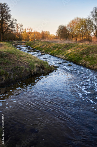 Colorful stream and evening sky at sunset in spring in Brandenburg, Germany