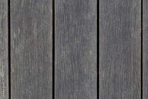 Top down view of grey wooden planks that makes up an outdoor walkway