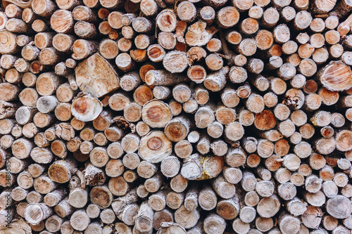 Background texture of stacked split firewood. Material for heating the house. 