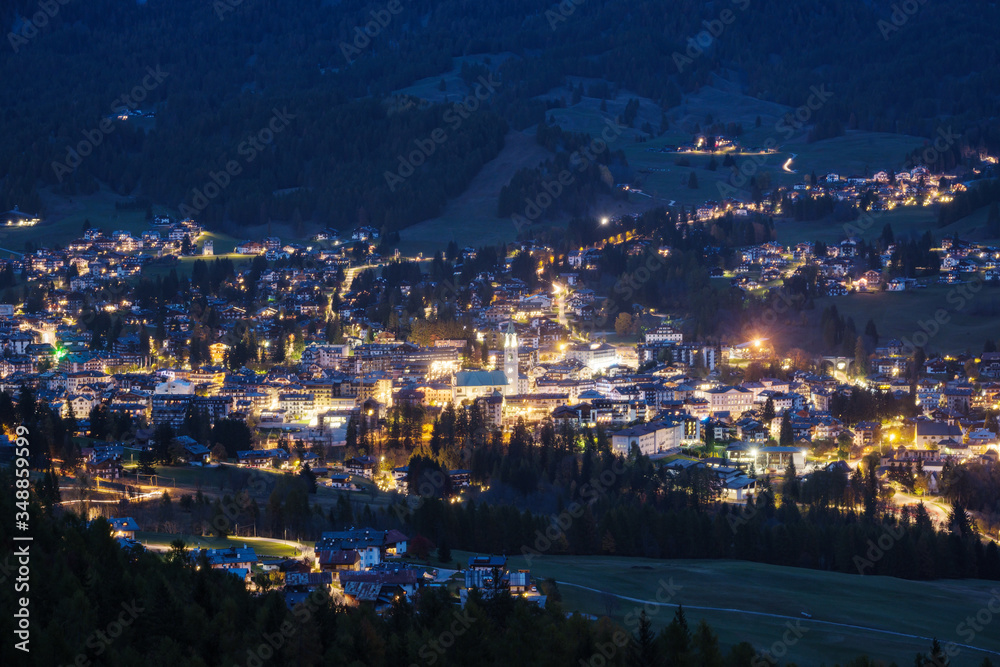 Autumn night Cortina d'Ampezzo alpine Dolomites mountain town, Belluno, Italy. Picturesque traveling and countryside beauty concept scene.