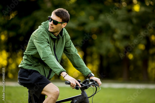 Young man riding ebike in nature