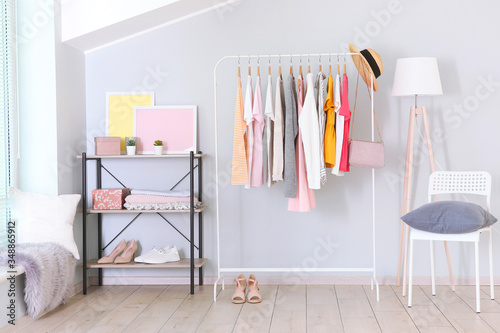 fashionable clothes on a rack in a bright interior of the wardrobe room © White bear studio 