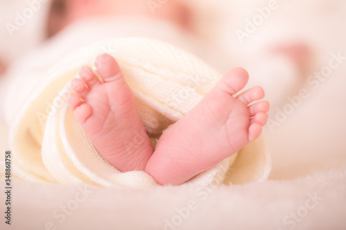 Tiny foot of newborn baby in soft selective focus.