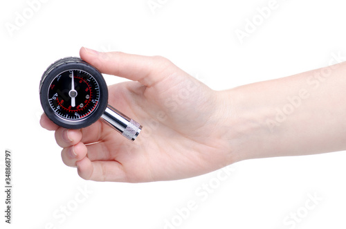 Automobile manometer tire gauge in hand on a white background isolation