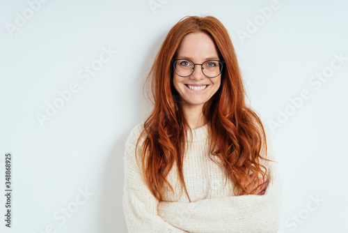 Fototapeta Happy vivacious young woman with long red hair