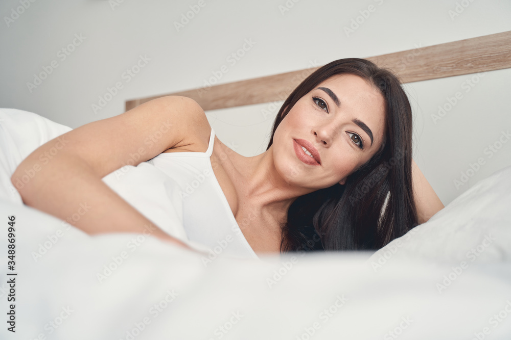 Lady wrapped in her duvet looking at the camera Lady wrapped in her duvet looking at the camera