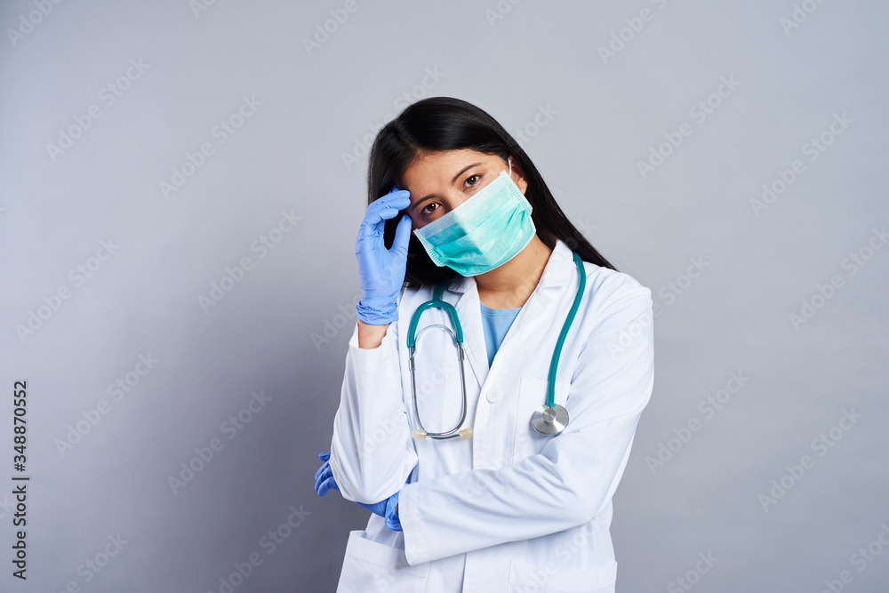 Tired female doctor in protective mask Tired female doctor in protective mask
