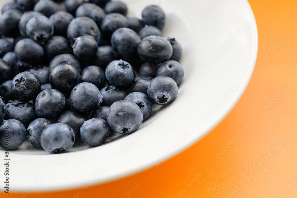 Natural looking blueberries in white plate. Selective focus. Natural looking blueberries in white plate. Selective focus.