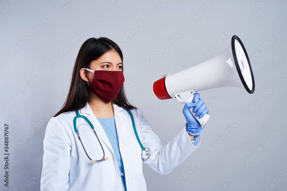 Female doctor screaming through the megaphone Female doctor screaming through the megaphone