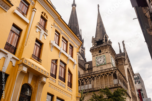 Church with pointed roof and yellow house