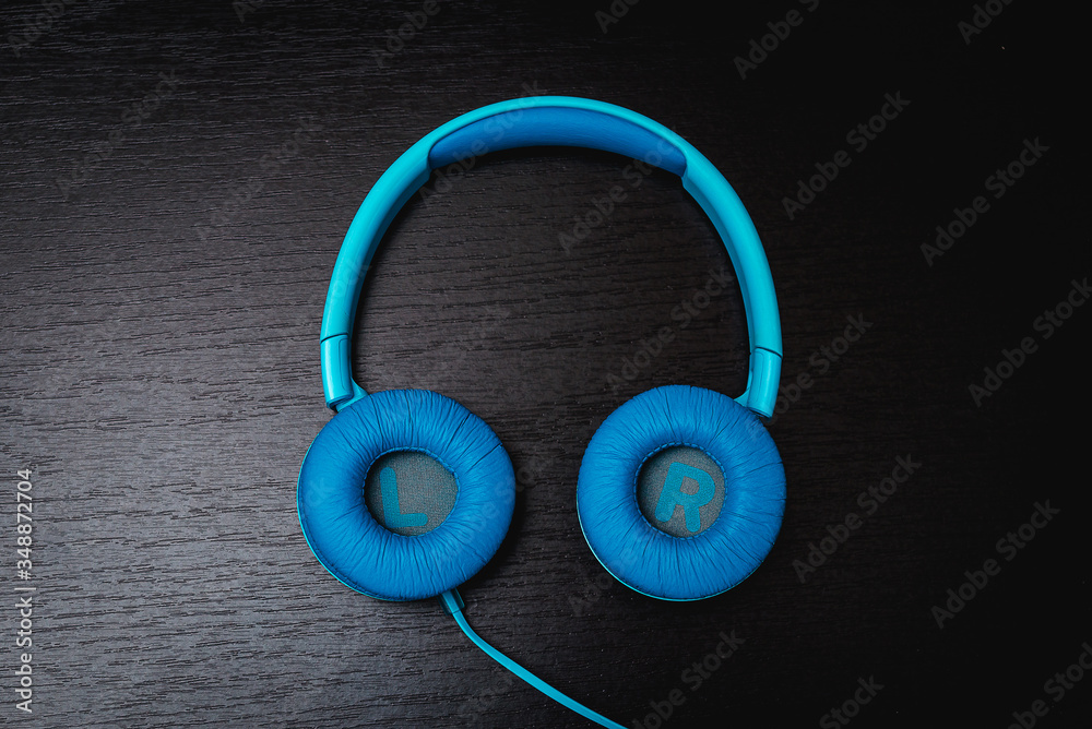 blue headphones on a black background blue headphones on a black background