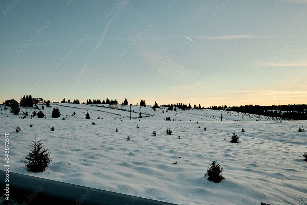 Winter morning during sunrise in the snowy Romanian countryside. Winter morning during sunrise in the snowy Romanian countryside.