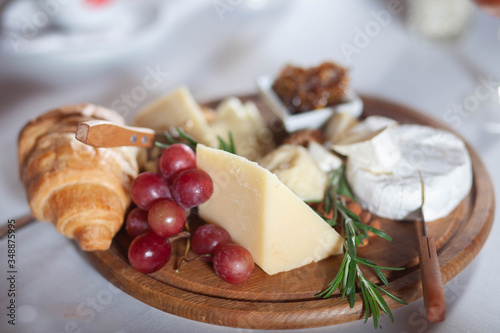 cheese plate on a wooden stand, which stands on a table