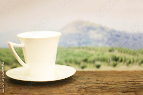 a cup of coffee on wood in the coffee plantation