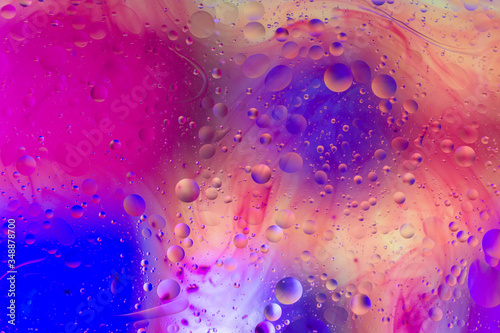 The purple abstract composition with oil drops in water.