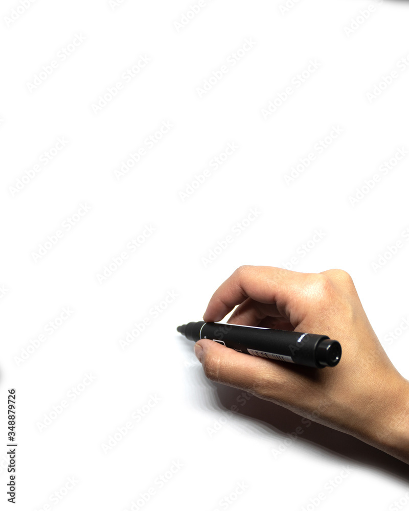 Female hand writes with black marker on white background. Female hand writes with black marker on white background.