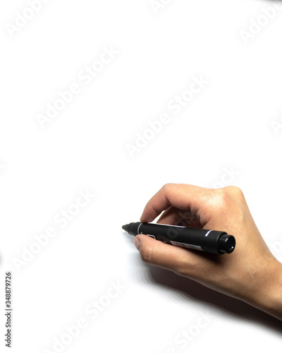 Female hand writes with black marker on white background.