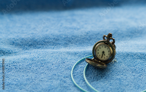 the old watch on blue tawel onn the table. photo