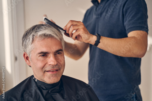 Portrait of male getting new fashionable hairstyle