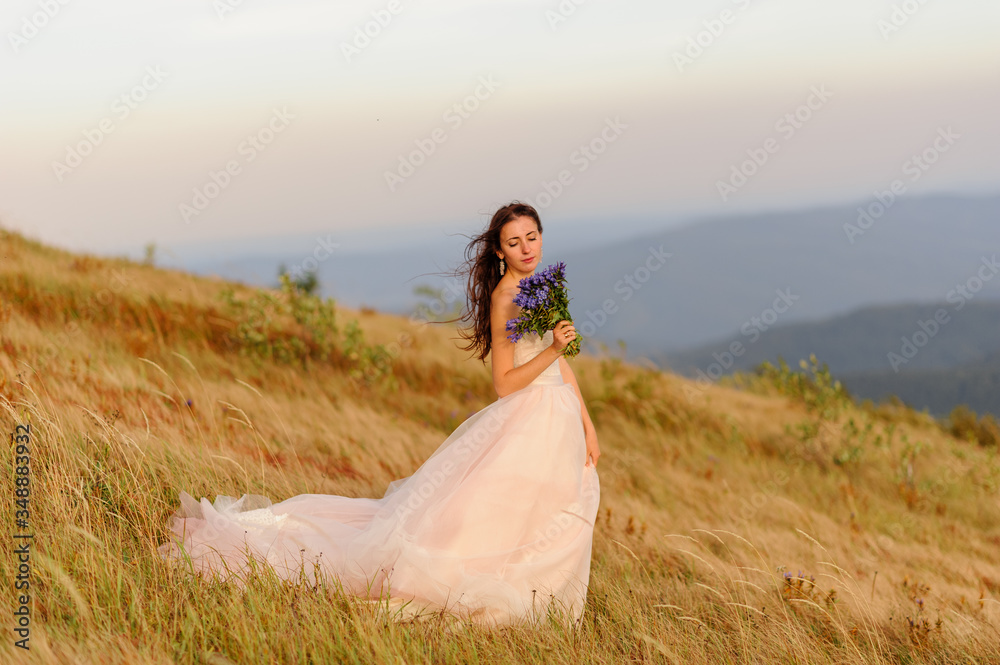 Portrait of a beautiful bride with a bouquet of wildflowers Portrait of a beautiful bride with a bouquet of wildflowers