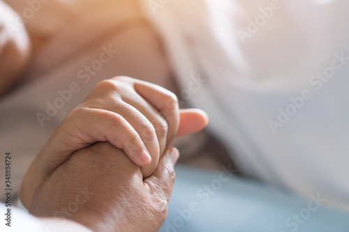 Loving couple holding hands  Hopeful  care love emotional concept  Together women hold hand lover while Sick Patients with Infusion pump infuses fluid. Encouragement comforting Recovering from family